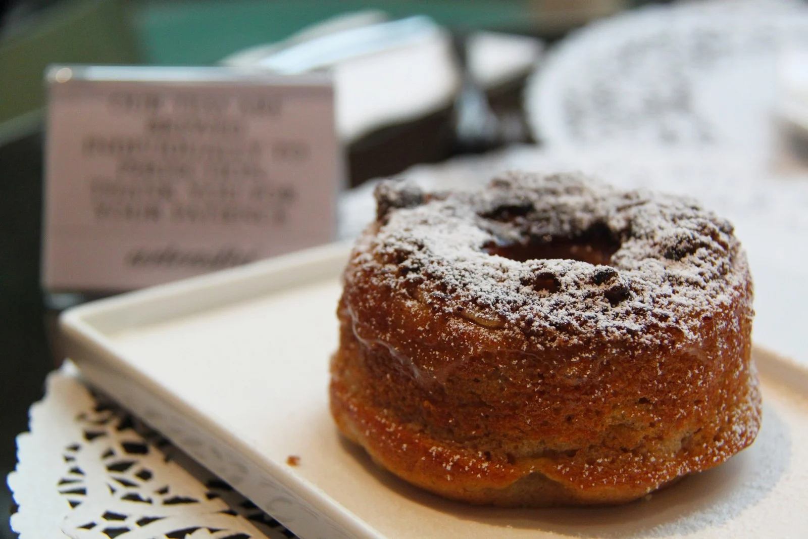 funnel cake donut with powdered sugar on top